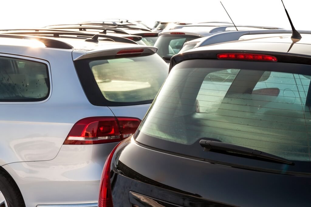 Parked Cars on a Lot. Row of New Cars on the Car Dealer Parking Lot. Cars for Sale Market Theme.